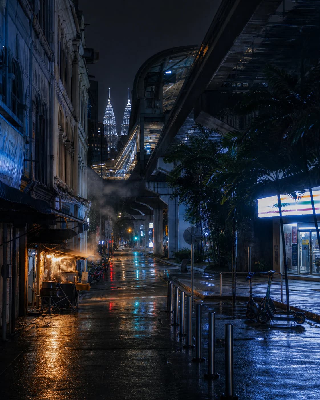 Bukit Bintang at 2 AM with the KL Monorail, Petronas Twin Towers, a late-night food stall, scooters, and a lit convenience store